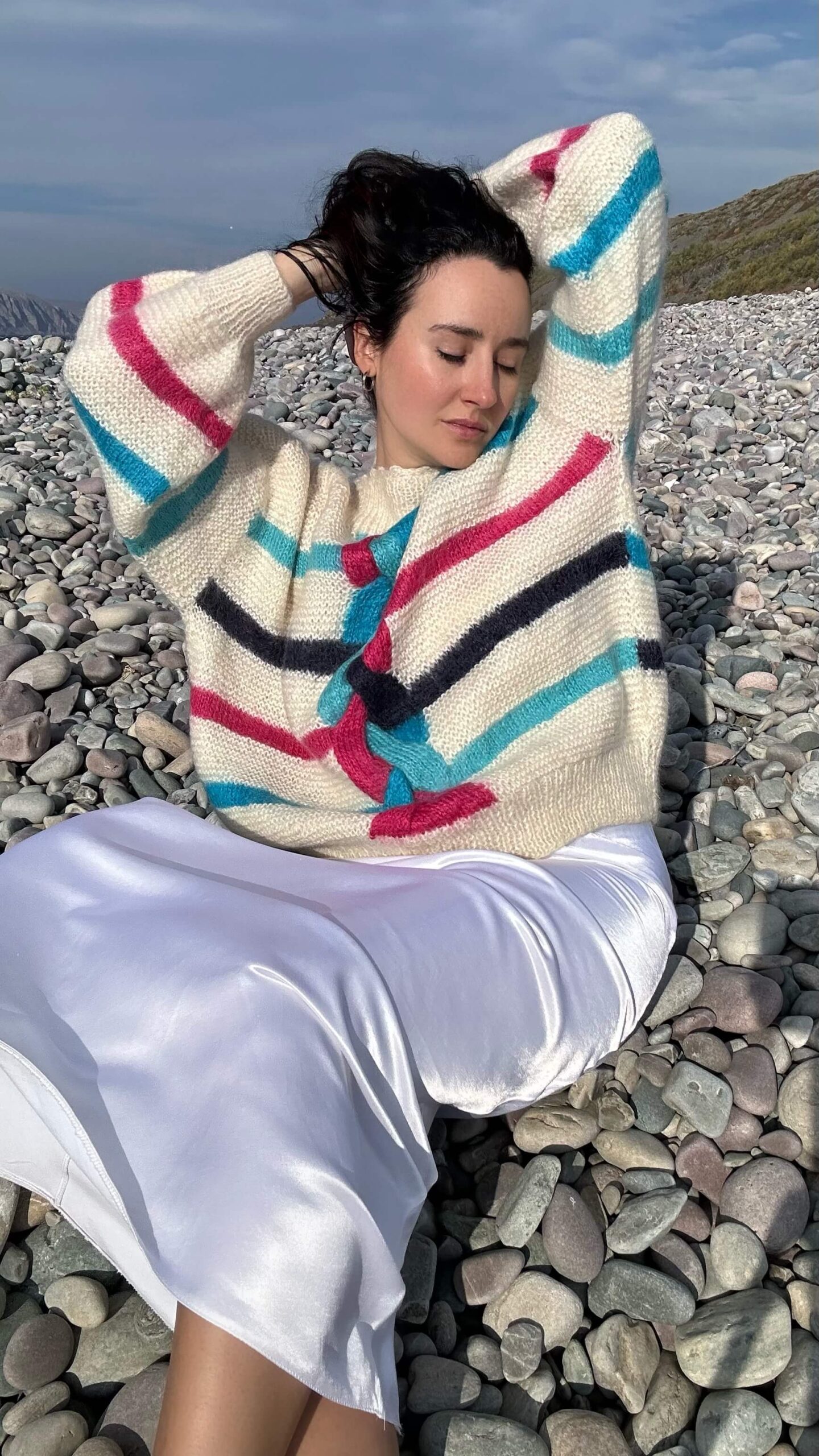 Hand-knitted soft beige sweater with colourful details
