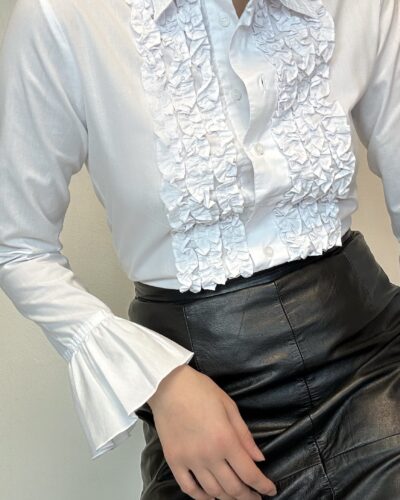 White blouse with a ruffle front and dramatic sleeves