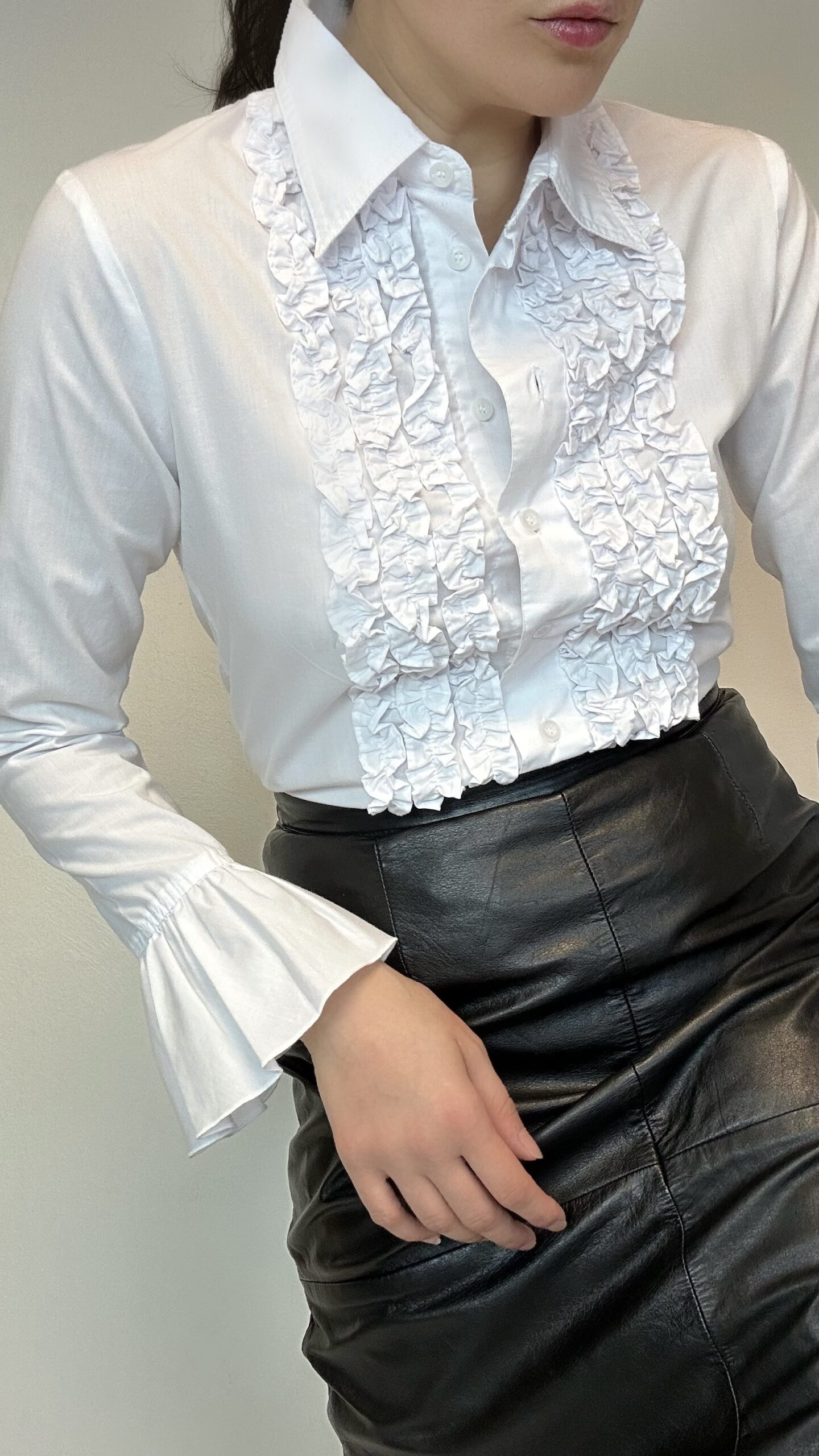 White blouse with a ruffle front and dramatic sleeves