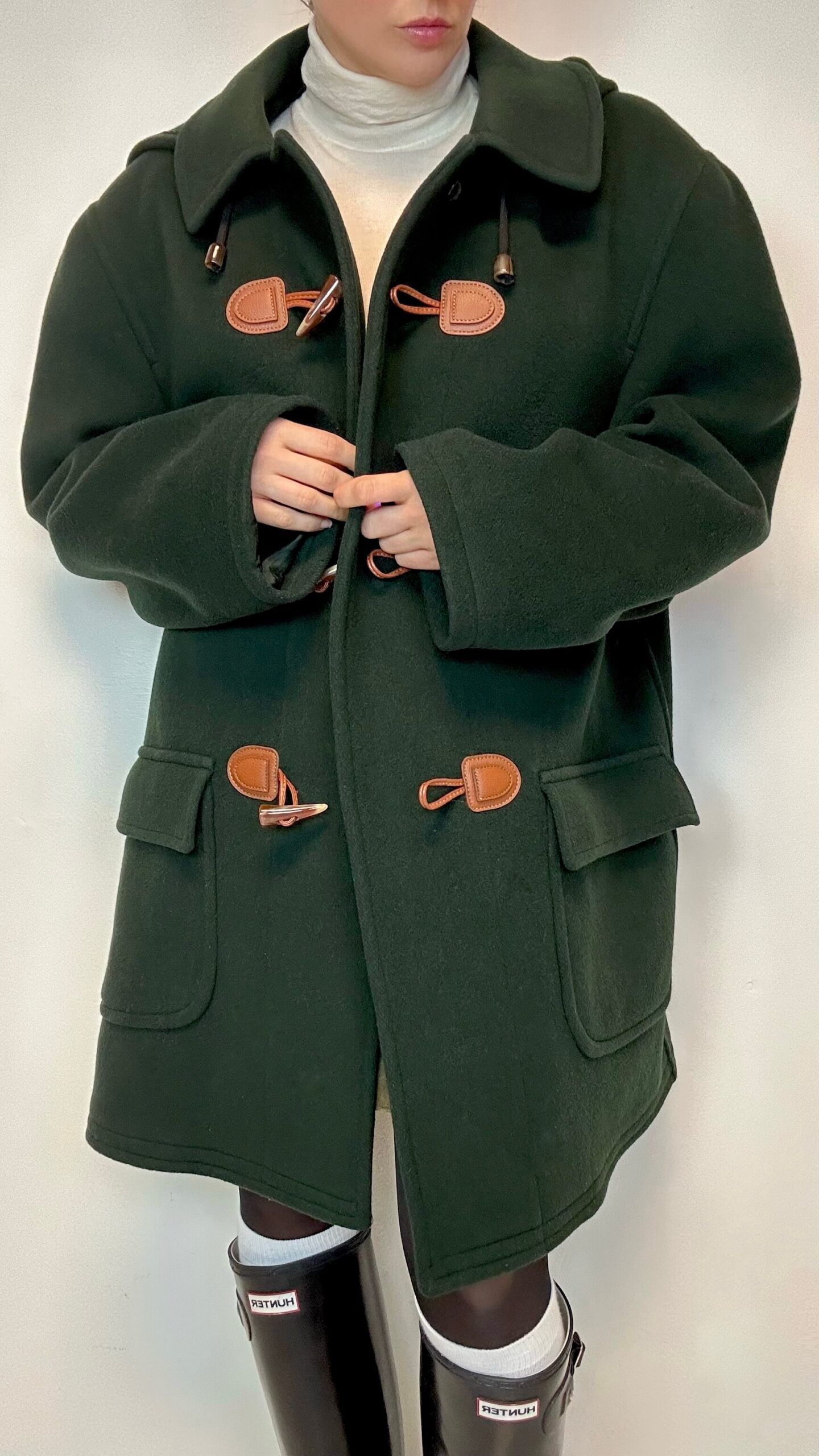 Green woolen winter duffle coat with bold shoulders