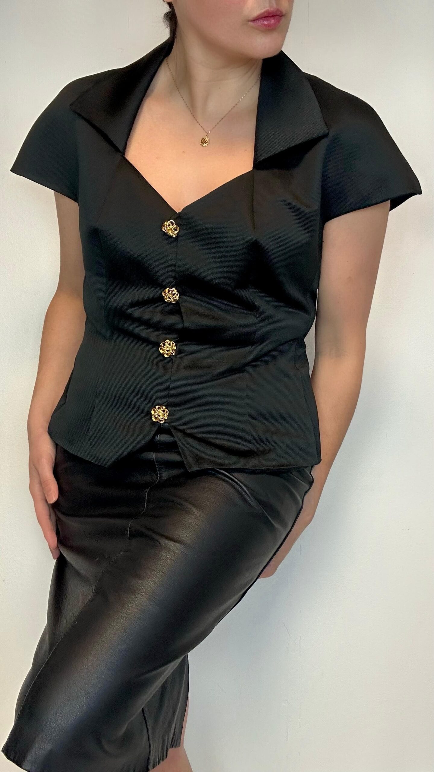 Structured black fitted blouse with cap sleeves